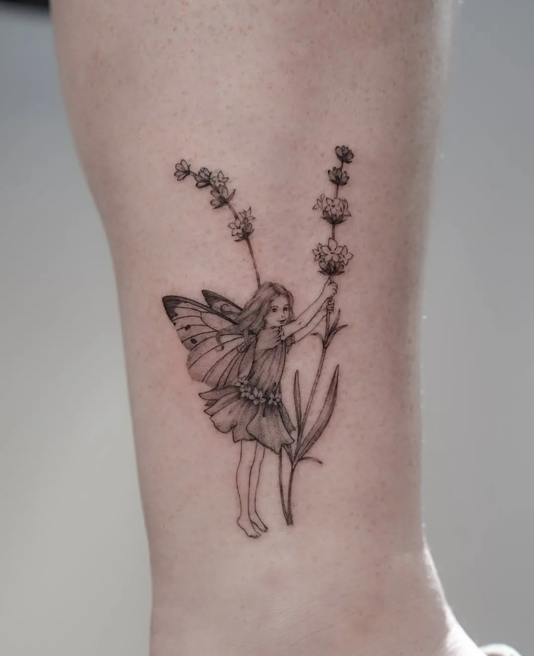 Delicate fairy surrounded by lavender flowers