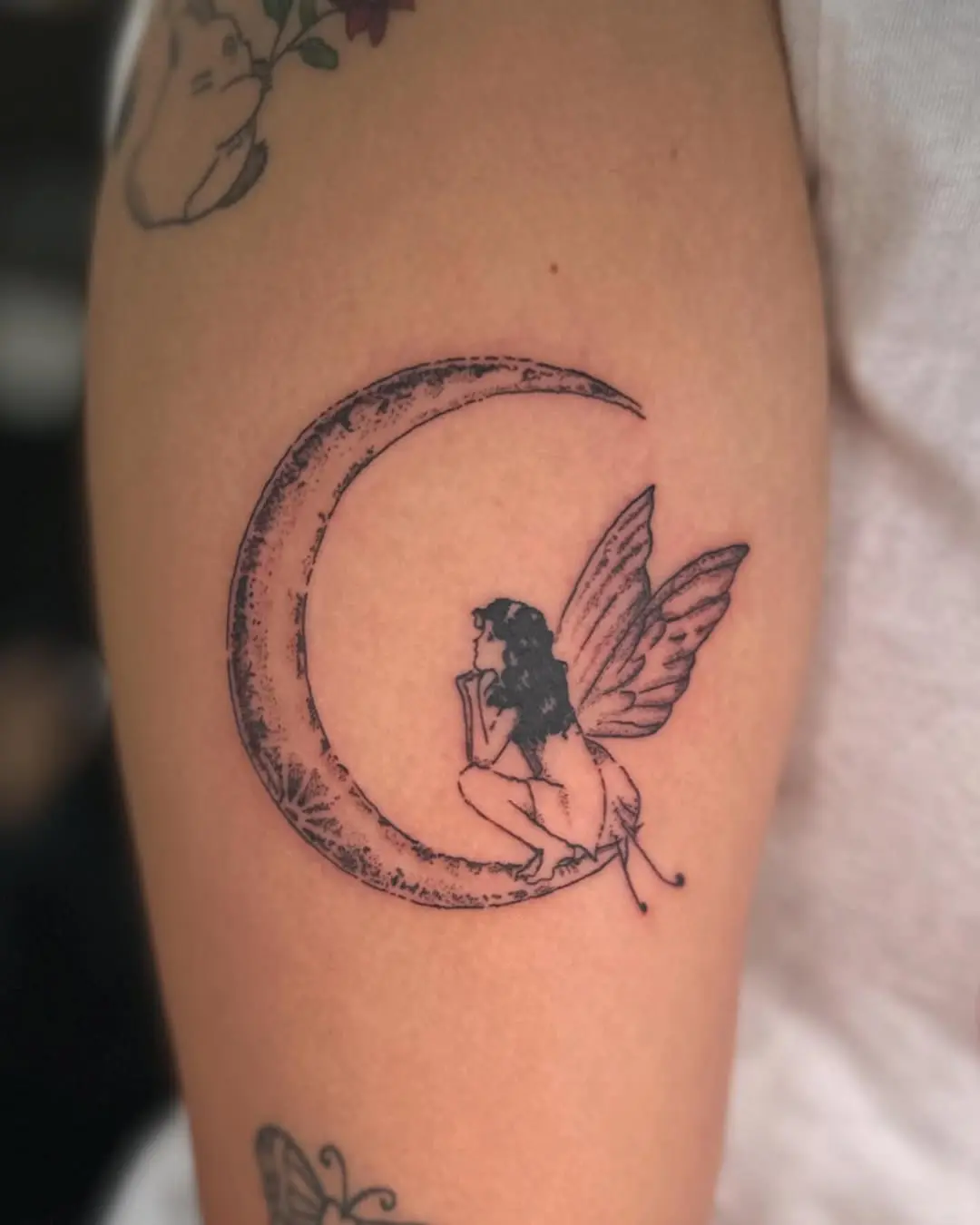 Enchanting fairy resting on a crescent moon
