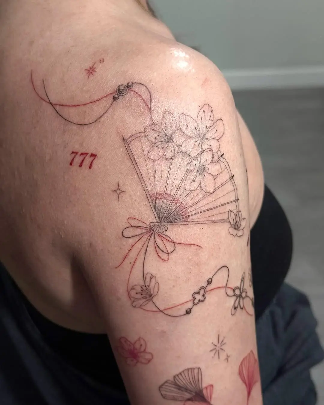 Elegant floral tattoo design featuring 777