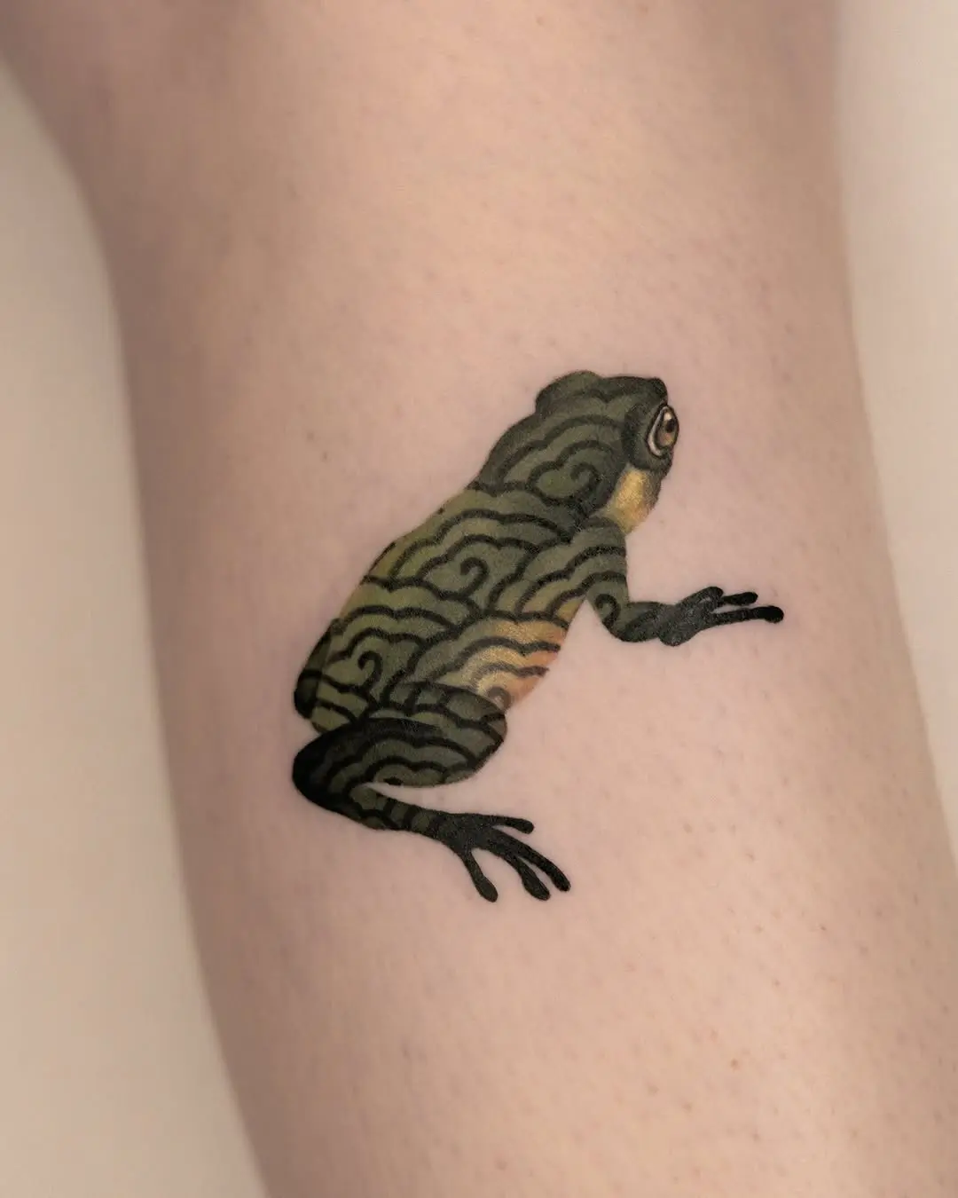 Artful frog tattoo with swirling patterns