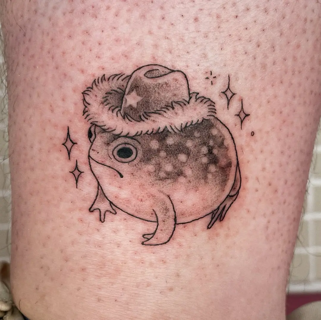 Charming frog tattoo wearing a cowboy hat