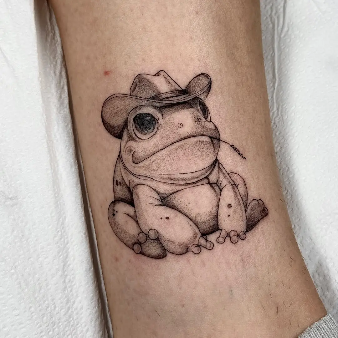Charming frog tattoo with a cowboy hat
