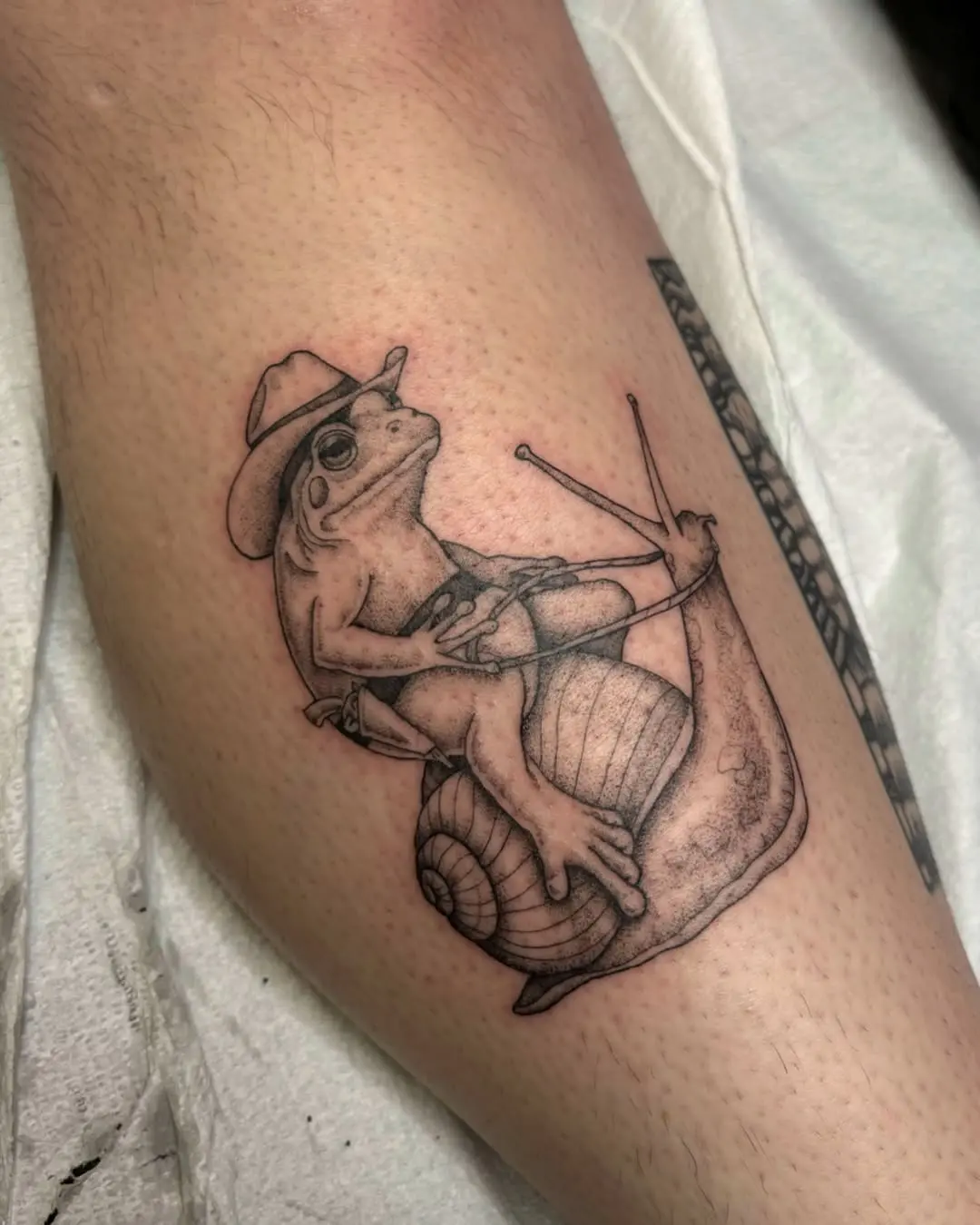 Frog tattoo with a playful cowboy twist