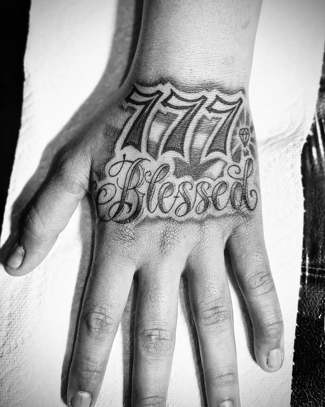 Expressive 777 Tattoo with 'Blessed' Message