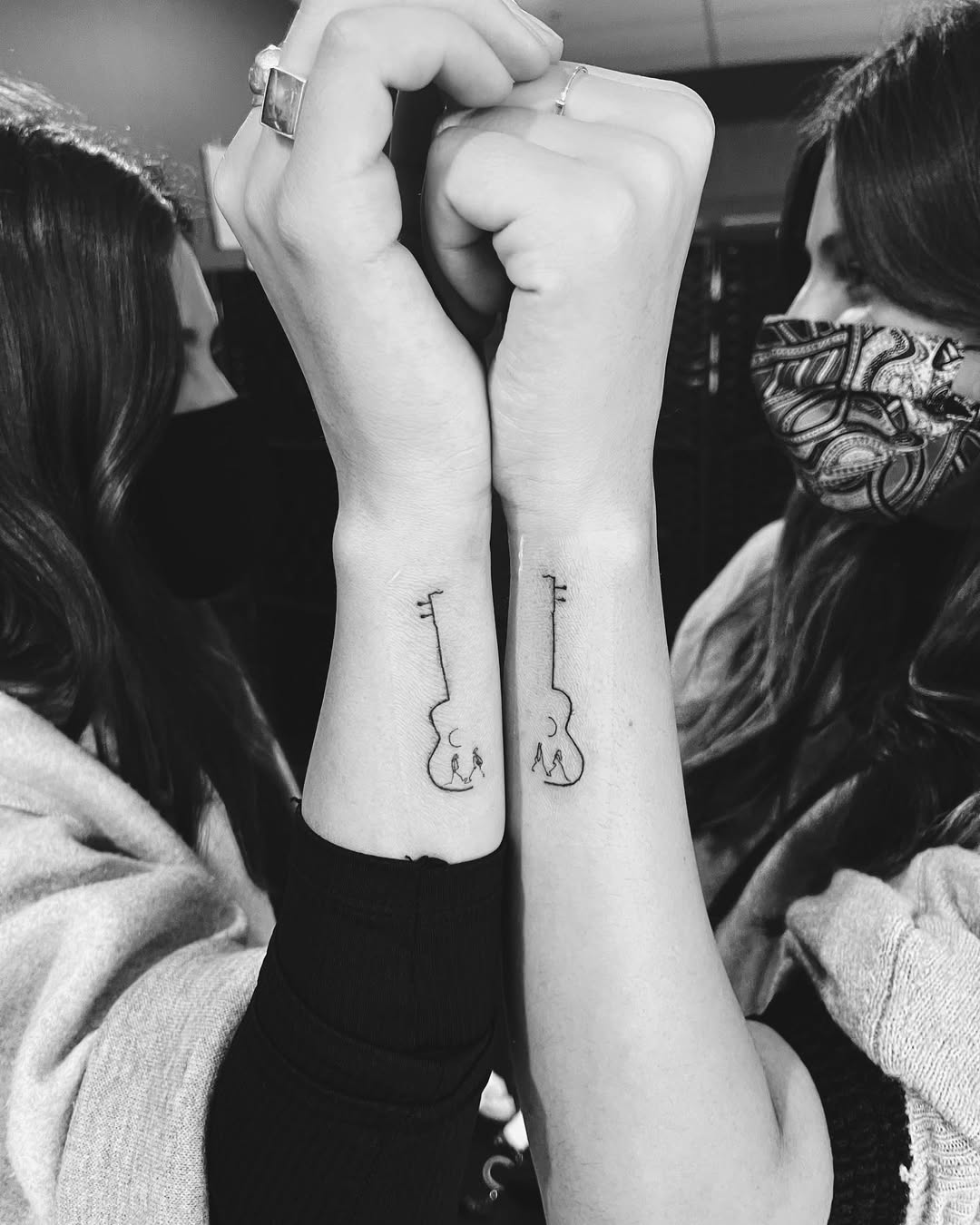 Symbolic twin key tattoos unite connection.