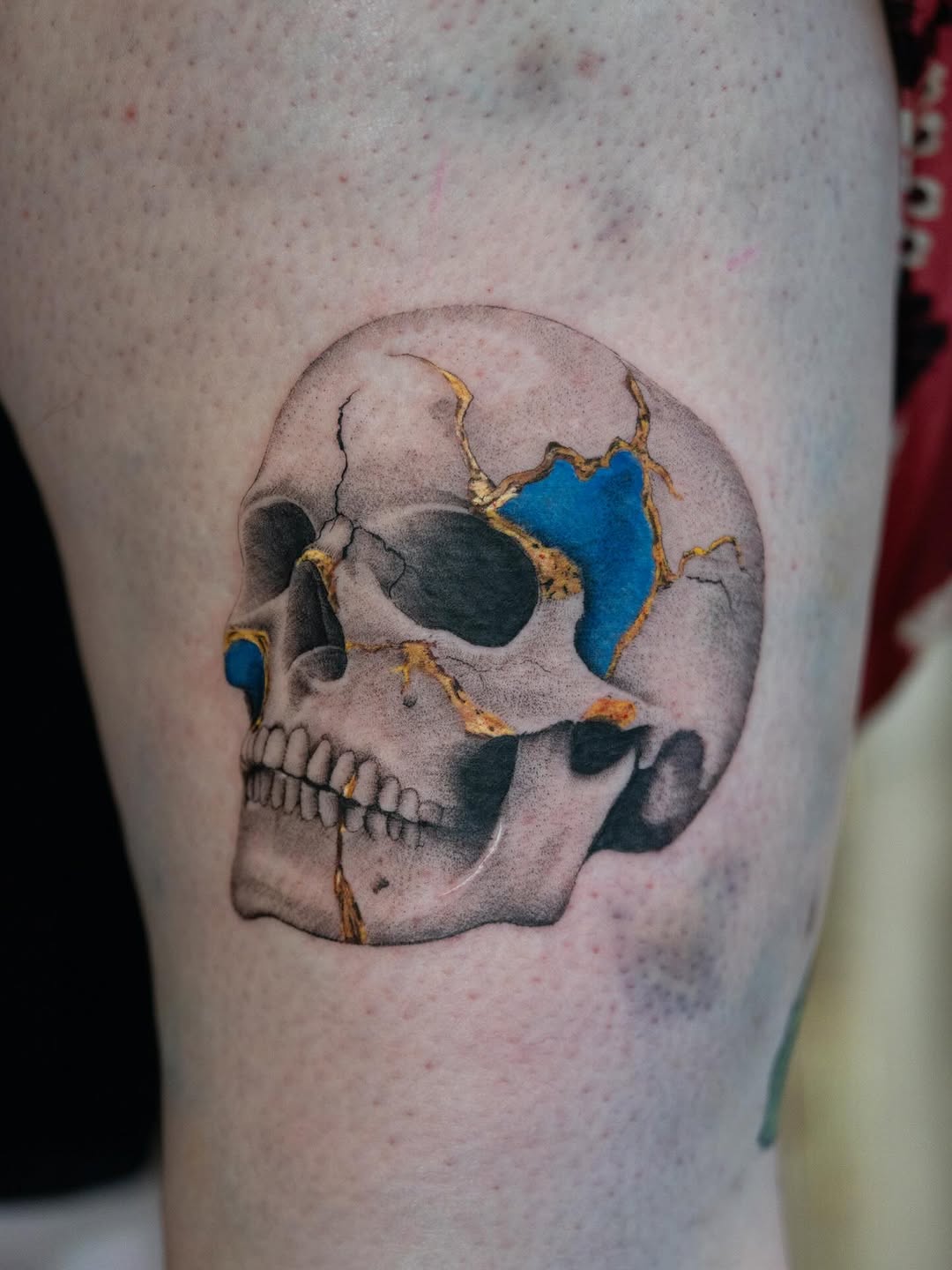 Artful skull tattoo showcasing kintsugi technique