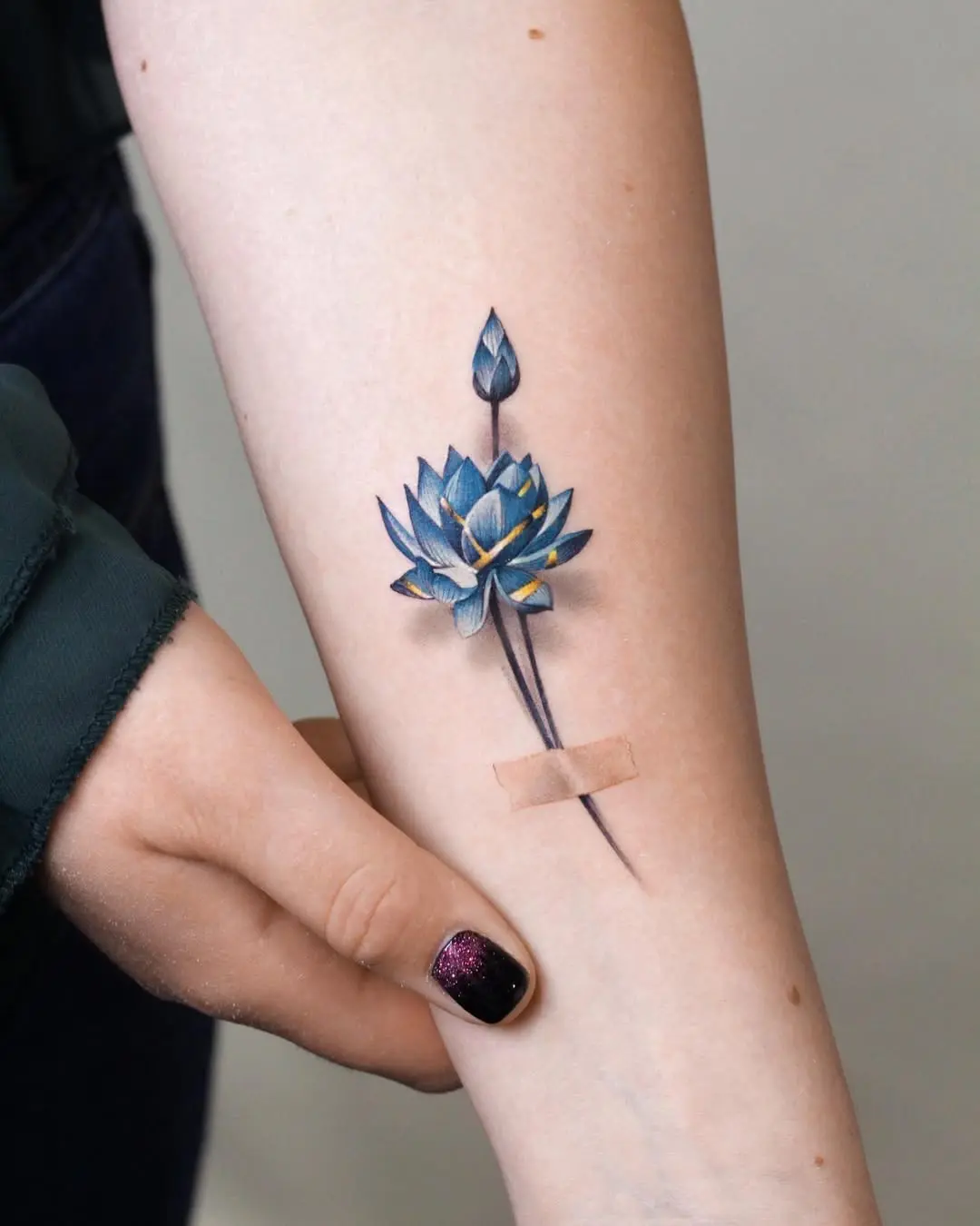 Serene lotus tattoo symbolizes strength and beauty.