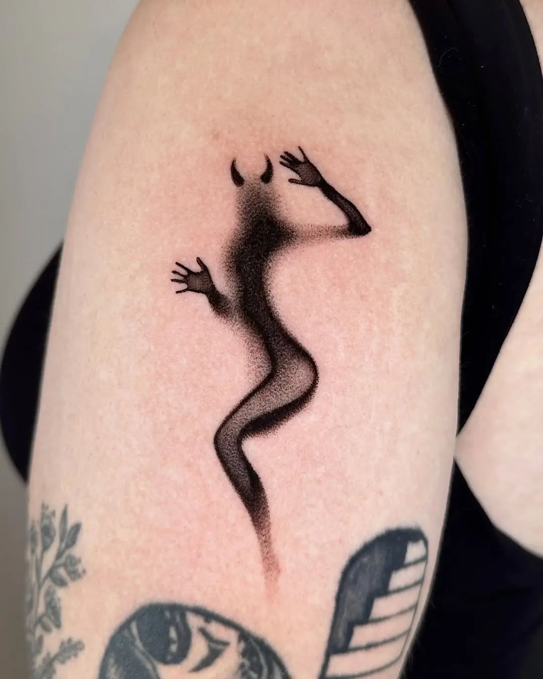 Unique minimalist devil-themed tattoo design