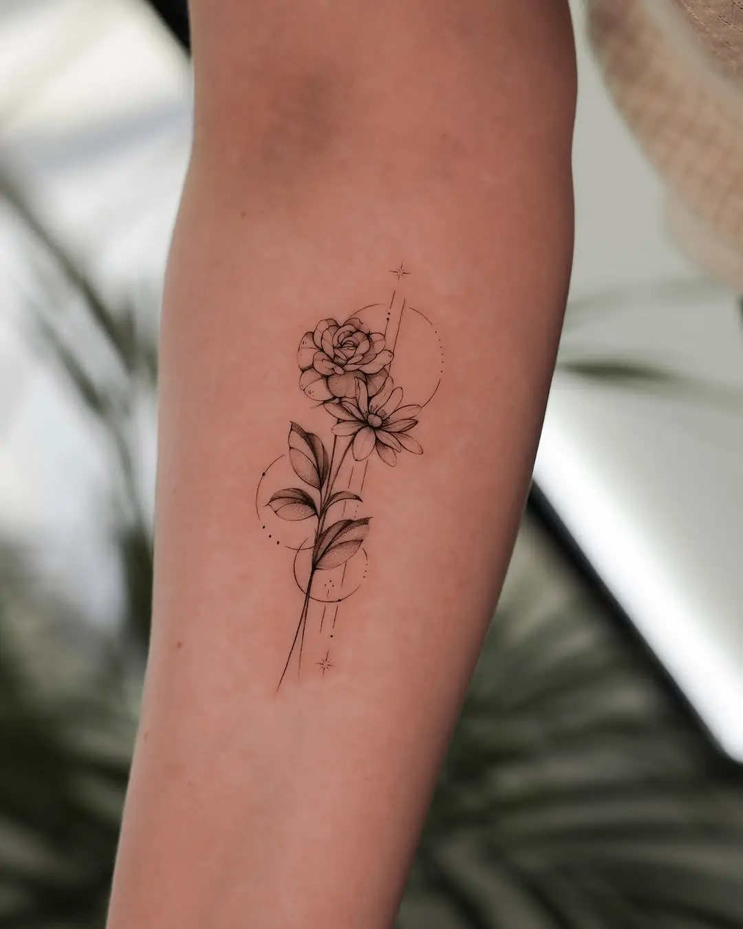 Elegant floral minimalist tattoo design on forearm