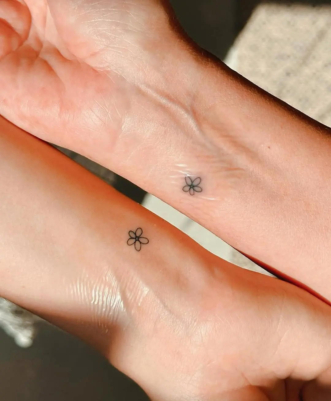 Charming minimalist flower tattoos on wrists