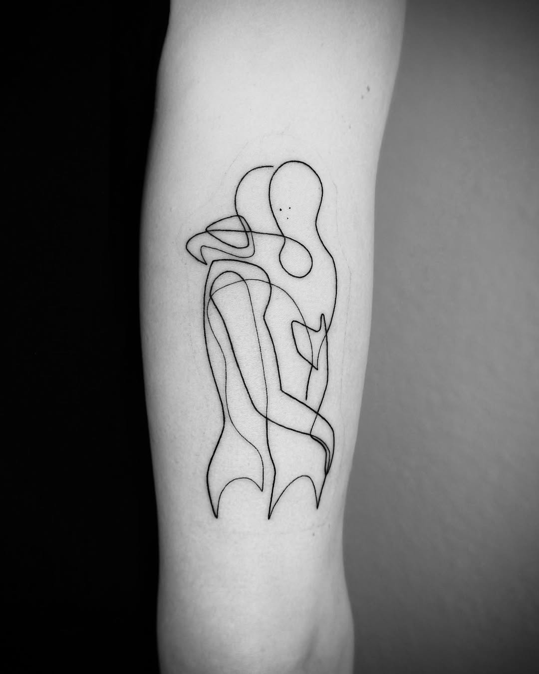 Elegant one-line embrace tattoo for connection