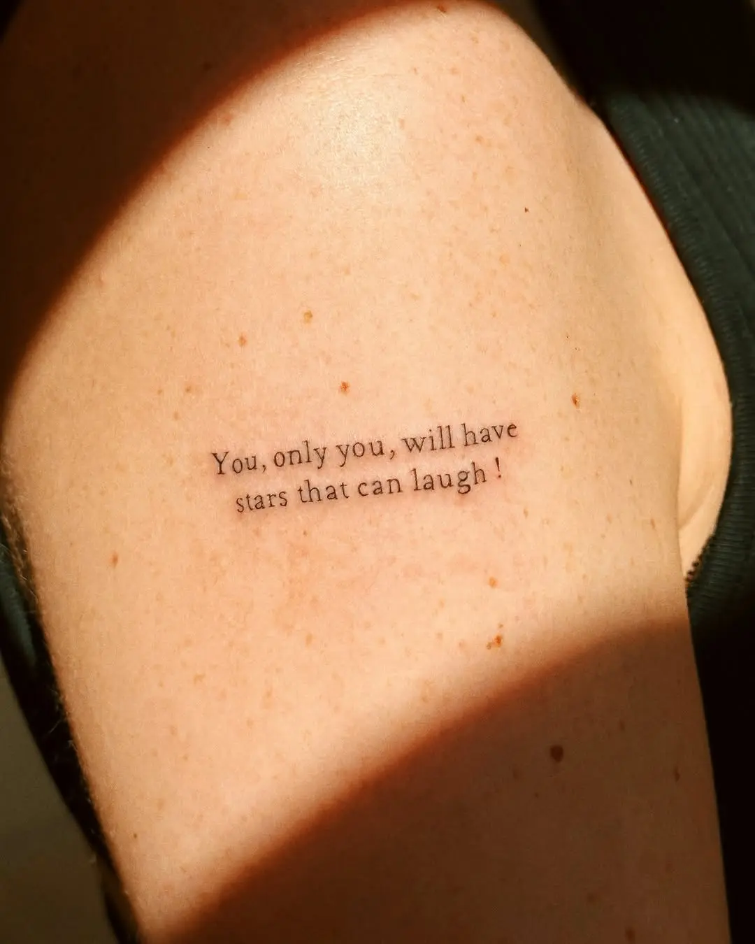 Elegant quote tattoo featuring cosmic inspiration