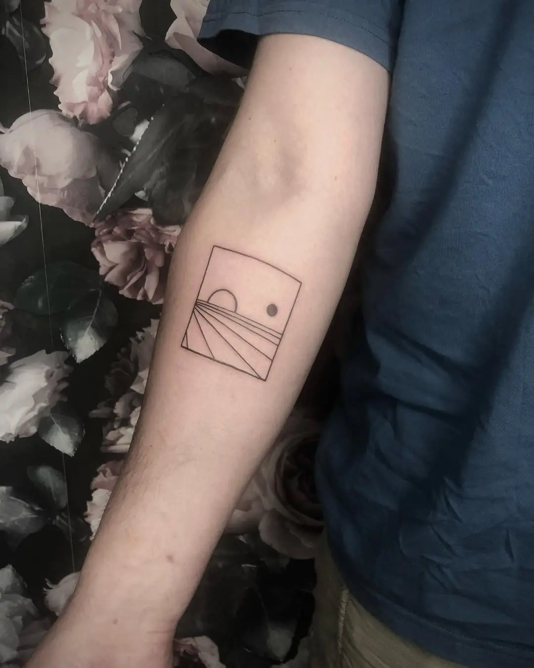 Simple geometric sunset tattoo on arm