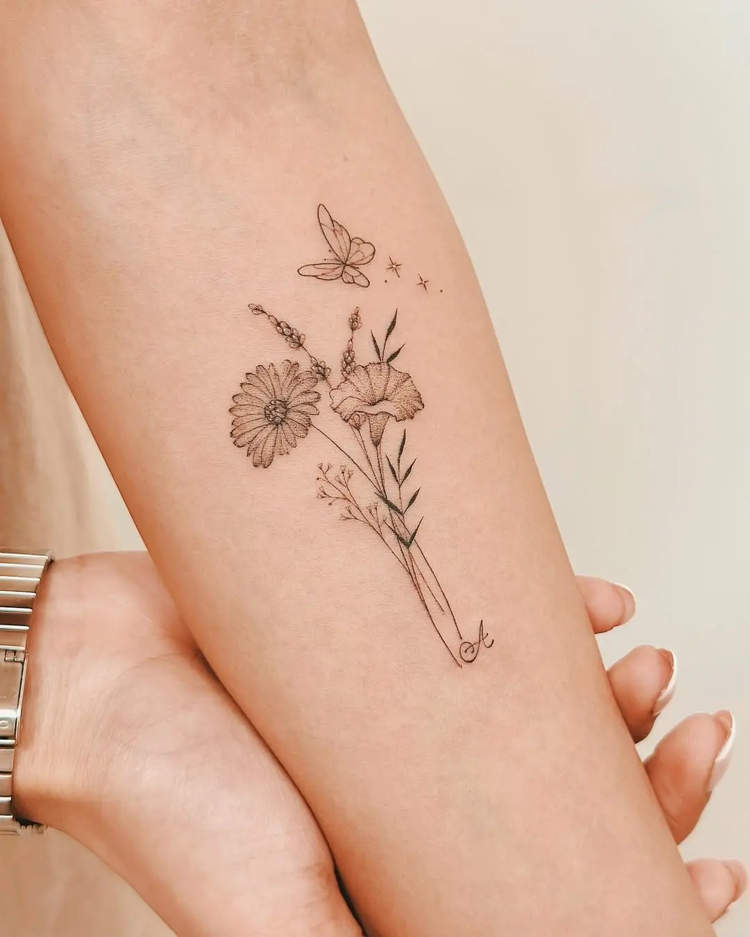 Delicate floral and butterfly minimalist tattoo design