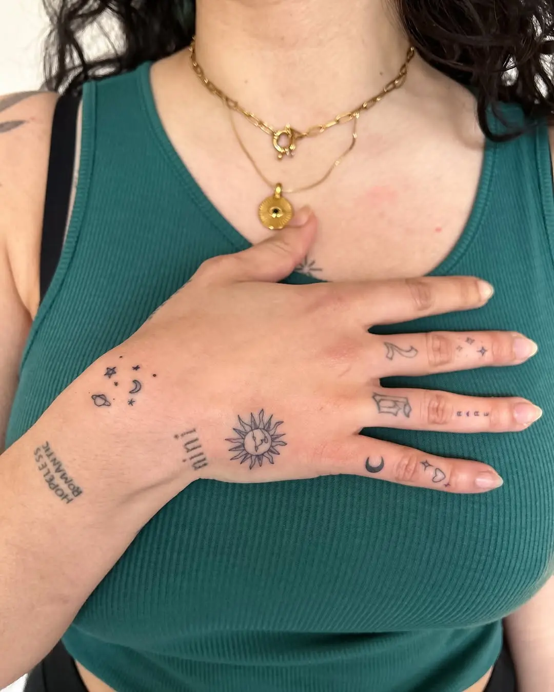 Charming minimalist tattoos on a hand
