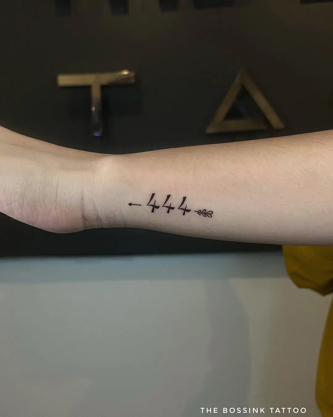 Stunning minimalist 444 tattoo with floral touch