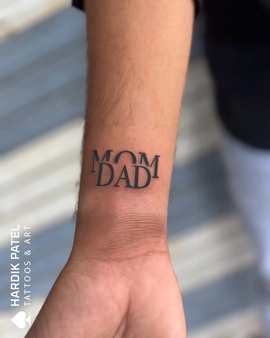 Elegant mom and dad tattoo on forearm