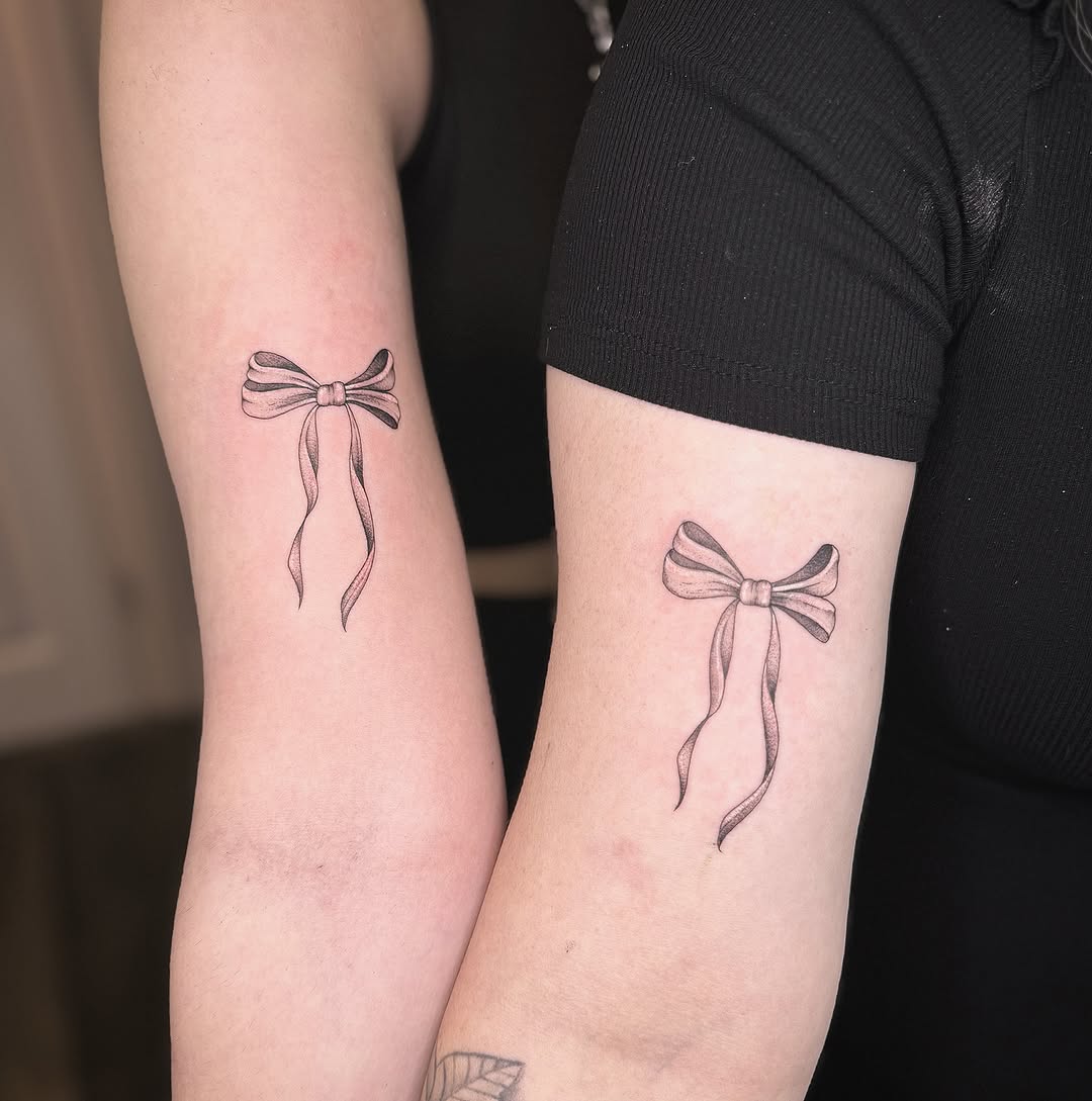 Elegant bow tattoos symbolizing mother-daughter bond