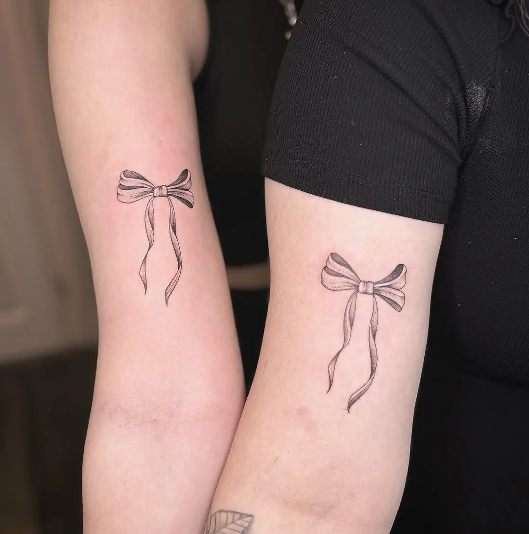 Elegant bow tattoos symbolizing mother-daughter bond
