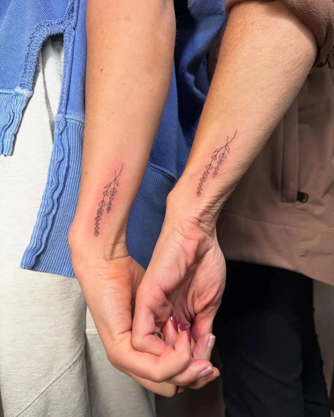 Delicate floral tattoos for mom and daughter.