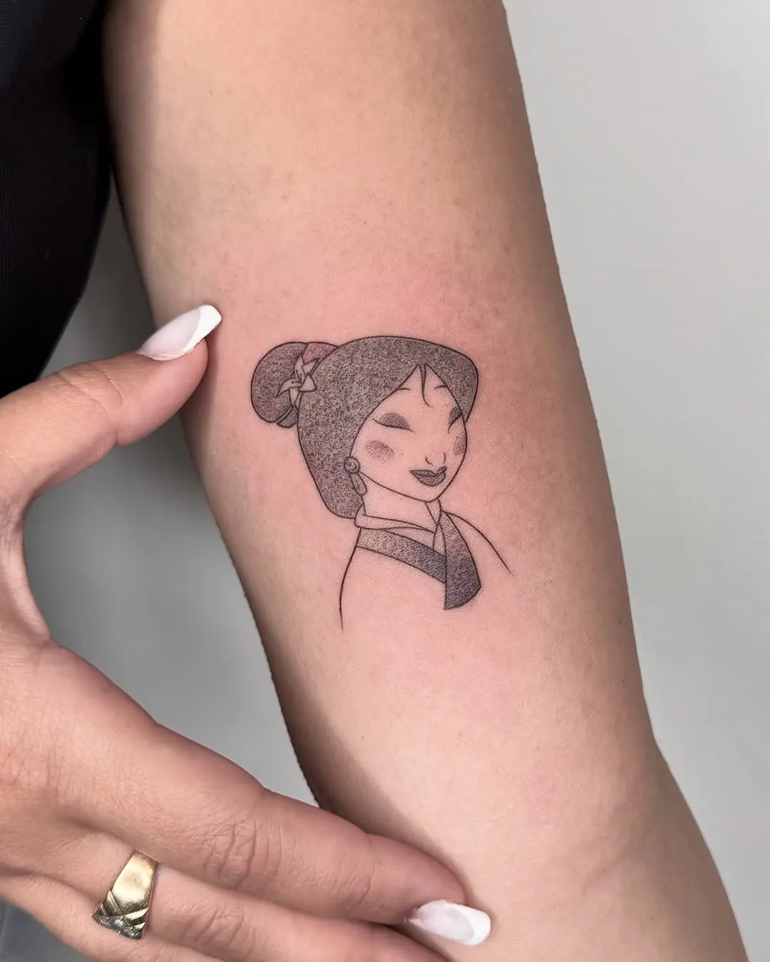 Elegant Mulan tattoo showcasing strength and grace