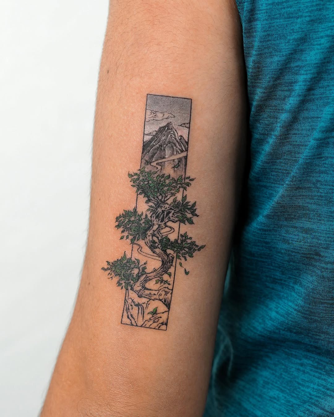 Stunning tree tattoo with a mountain view