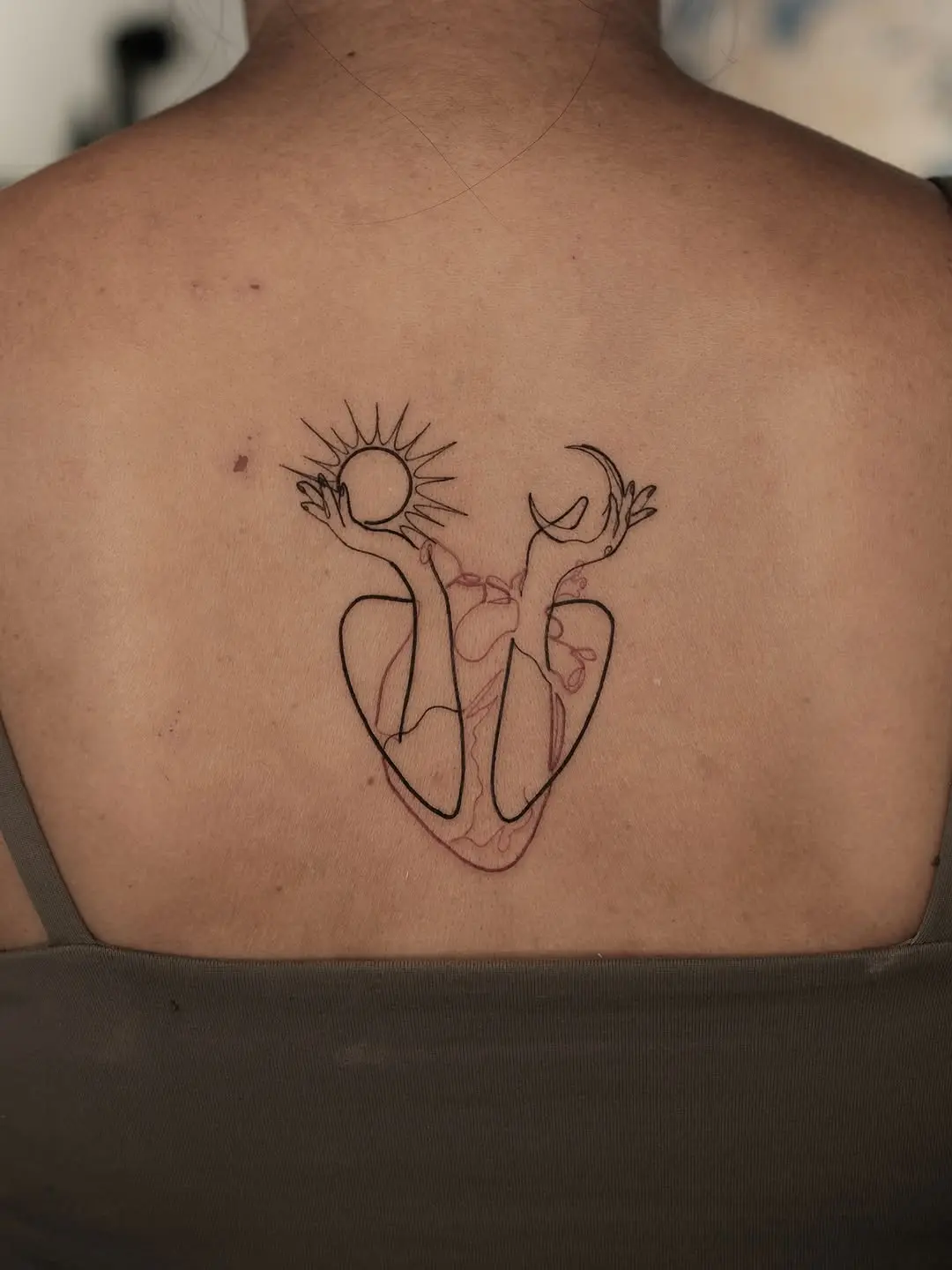 Tranquil one line sun and moon tattoo expression