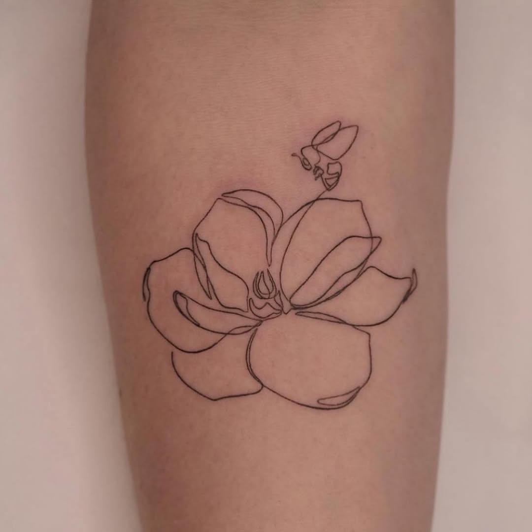 Elegant one-line floral tattoo with a bee