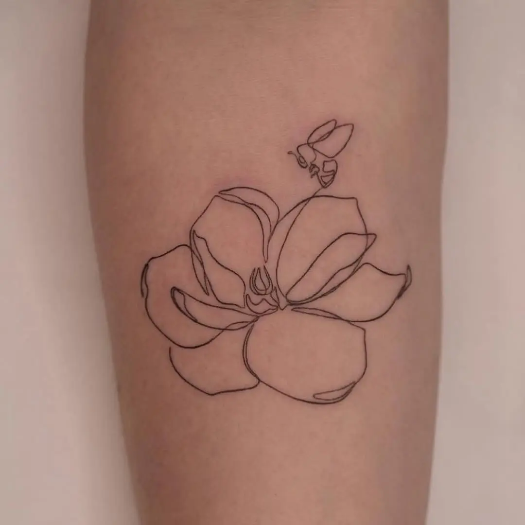 Elegant one-line floral tattoo with a bee