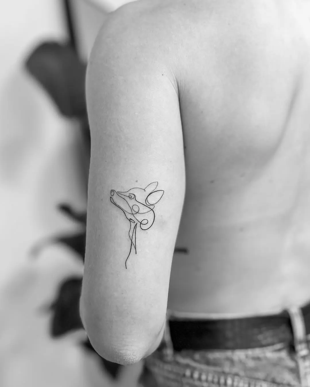 Minimalist tattoo showcasing a stylized animal face