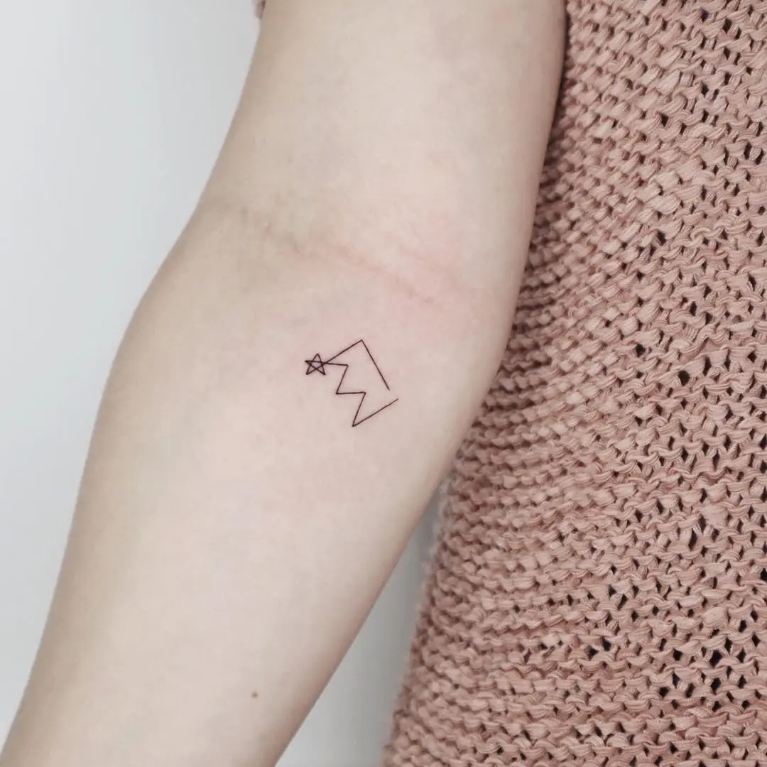 Minimalist mountain and star tattoo design
