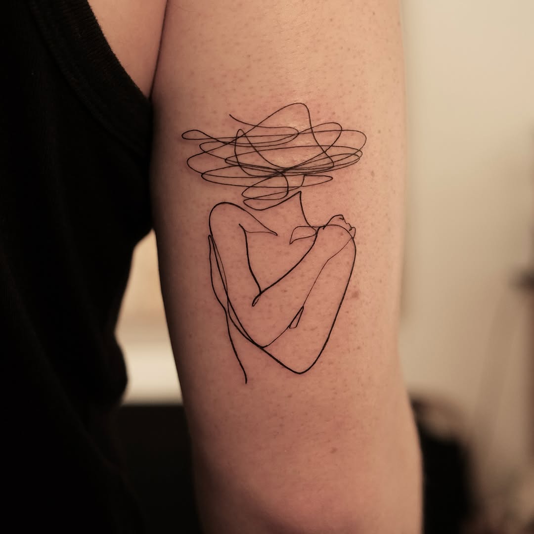 Minimalist one-line woman silhouette tattoo design