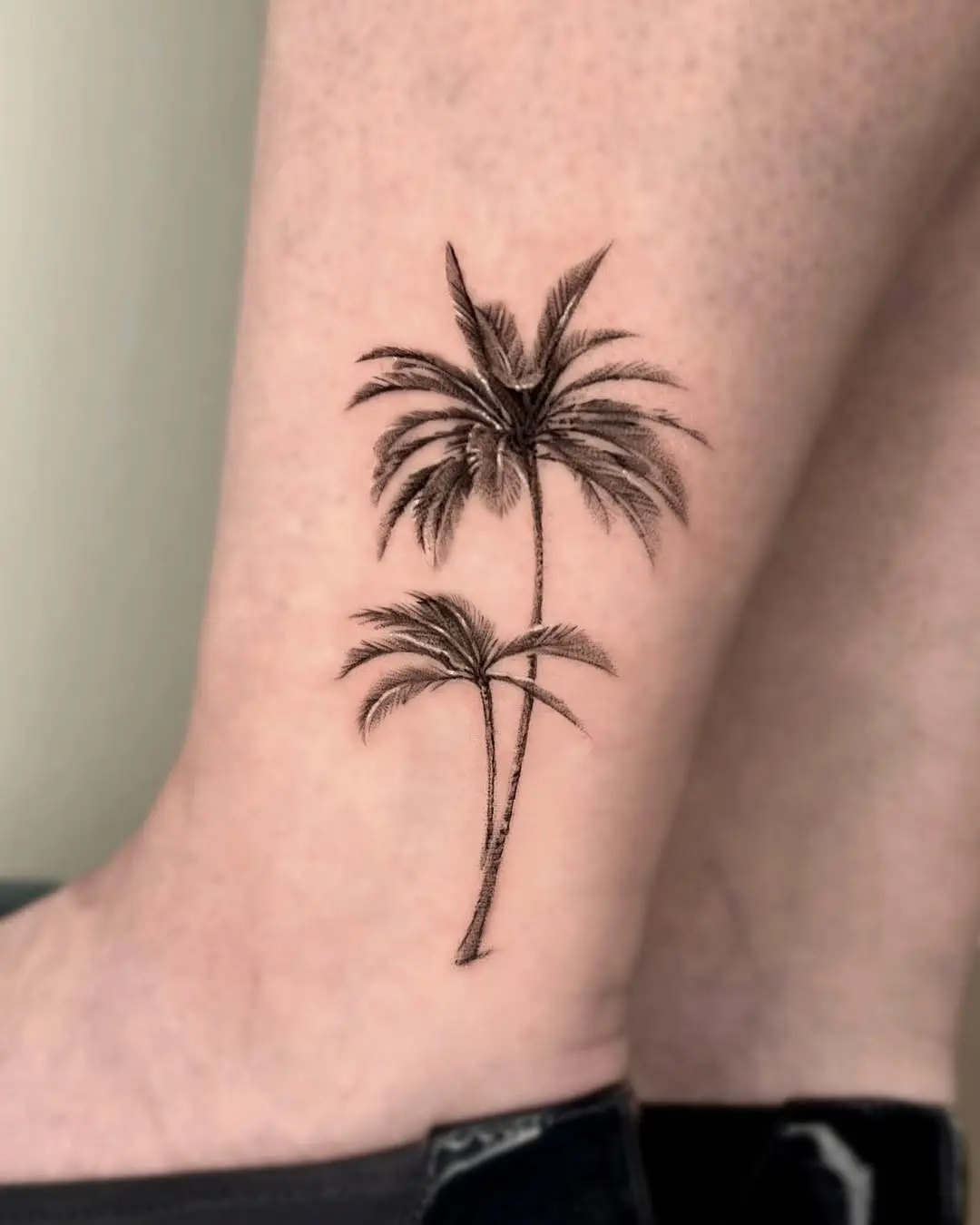 Elegant palm tree tattoo for a tropical vibe