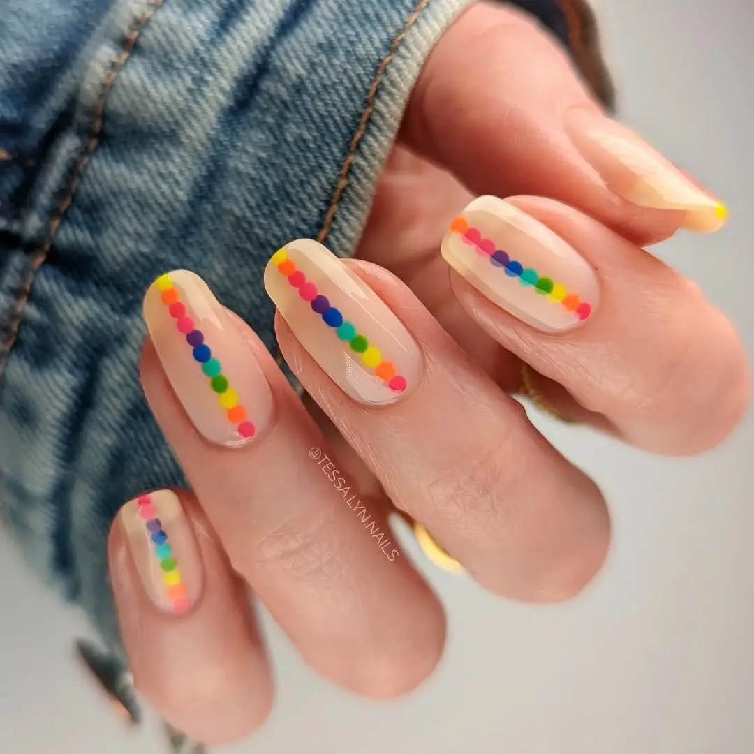 Playful rainbow dotted nail design