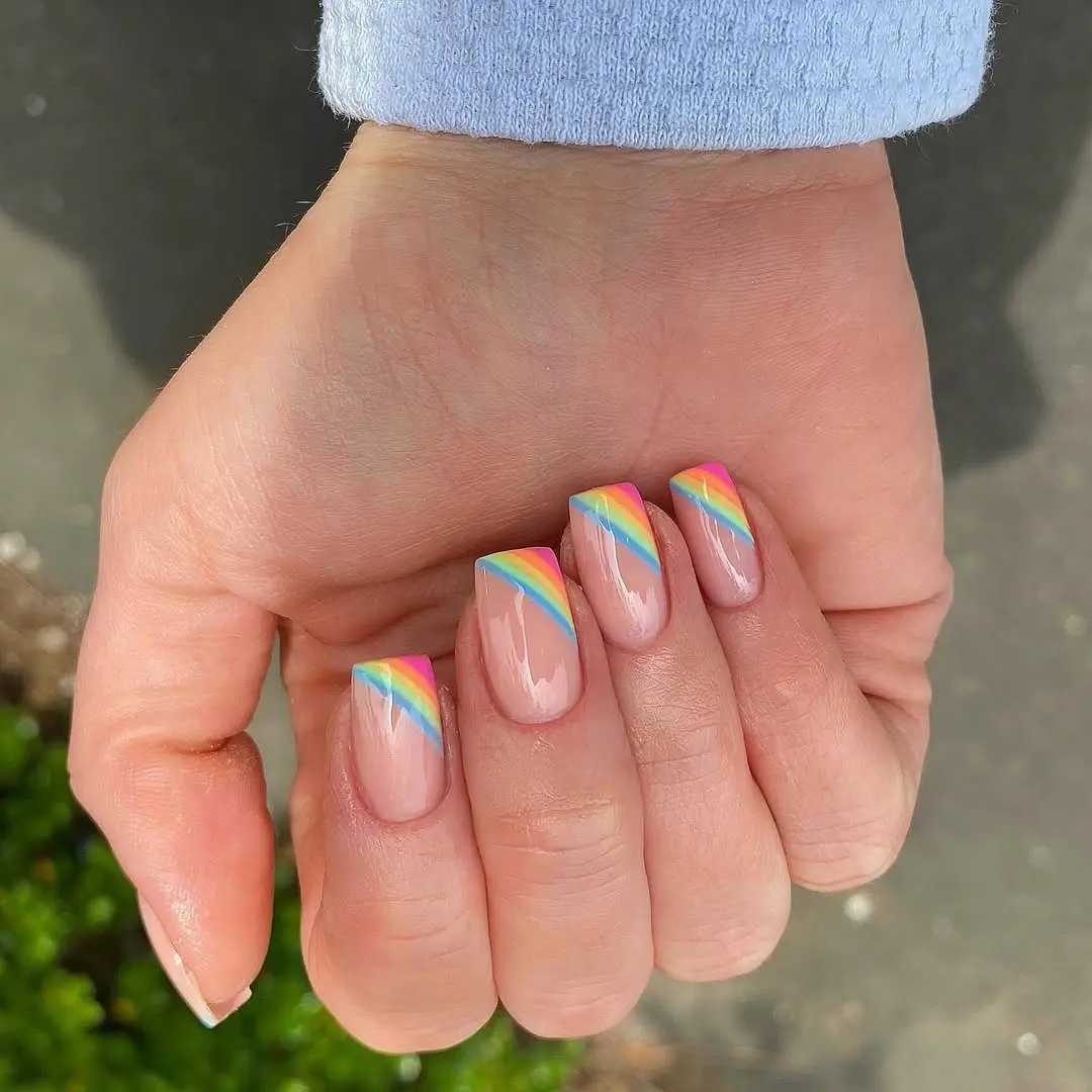 Chic rainbow nails with vibrant angled stripes