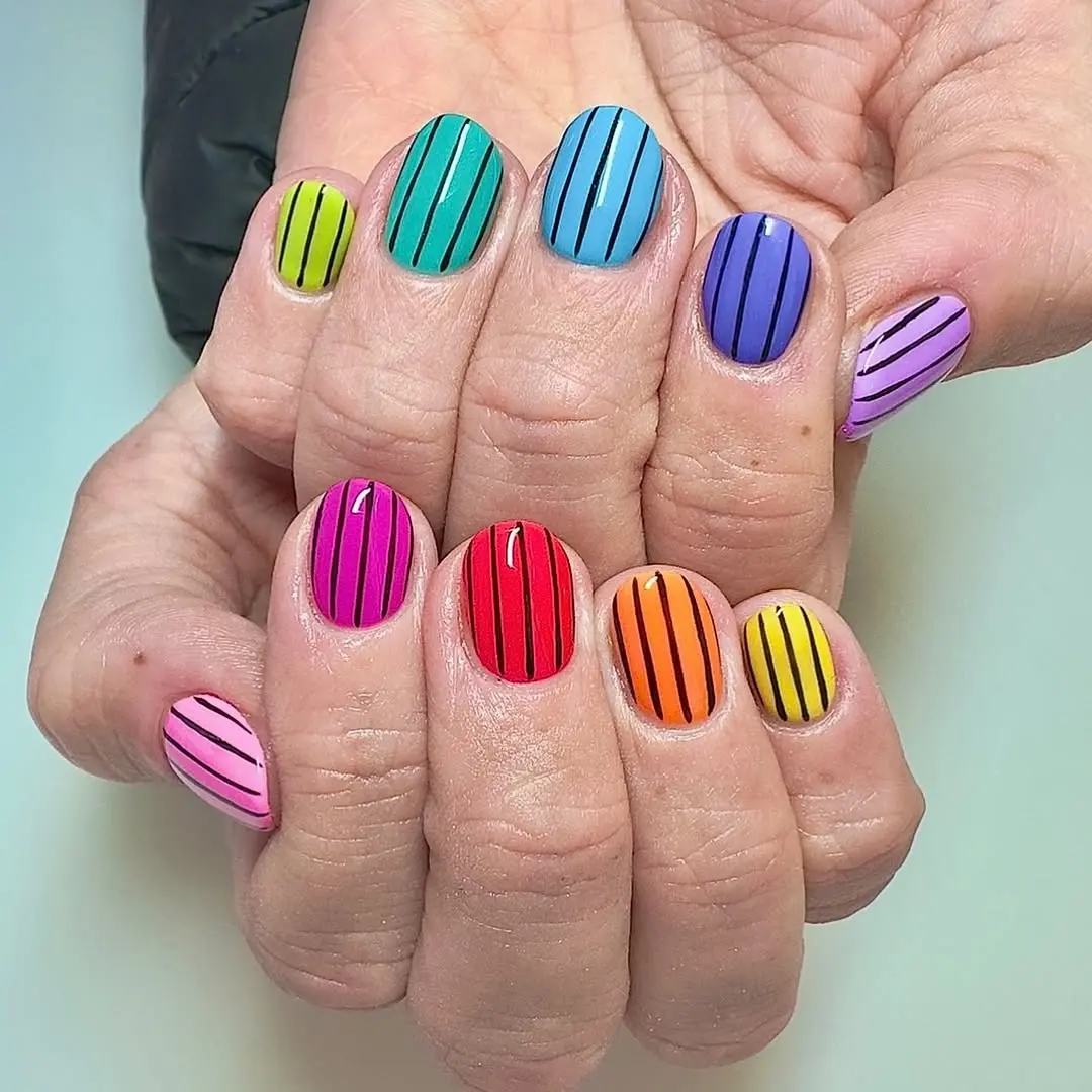 Vibrant rainbow nails with playful striped design