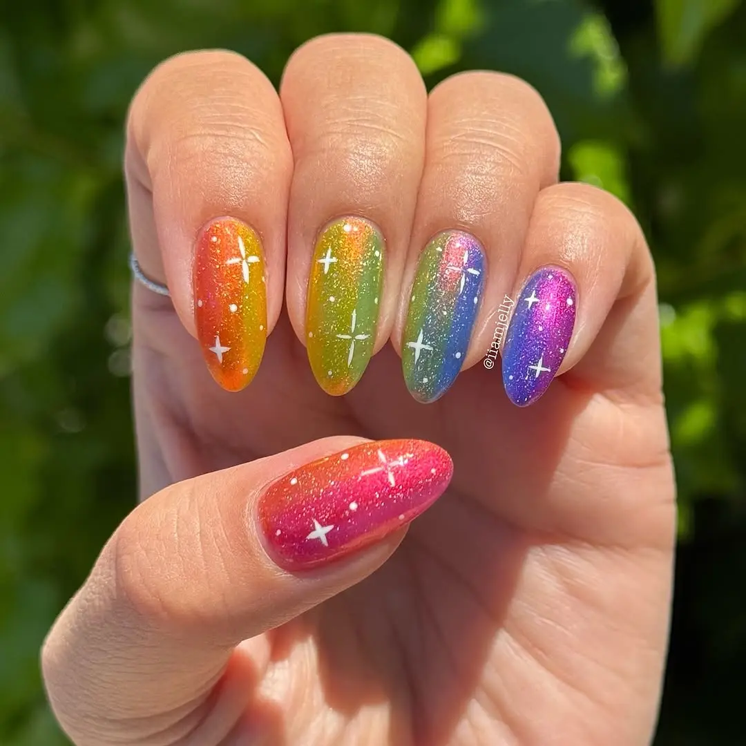 Vibrant rainbow nails with sparkling stars