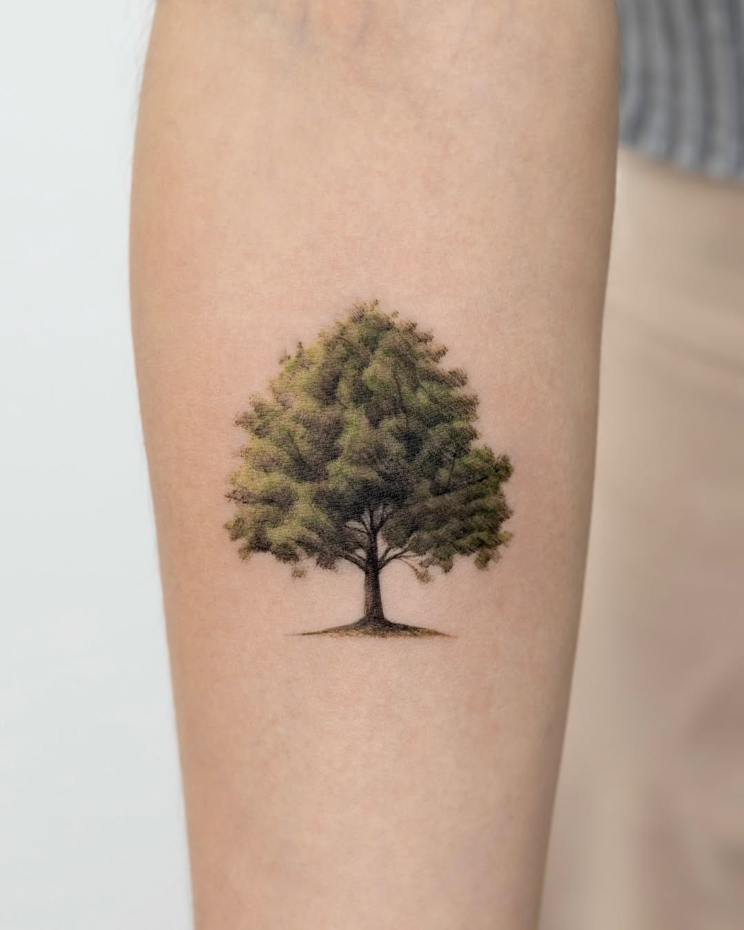 Elegant tree tattoo with vibrant green hues