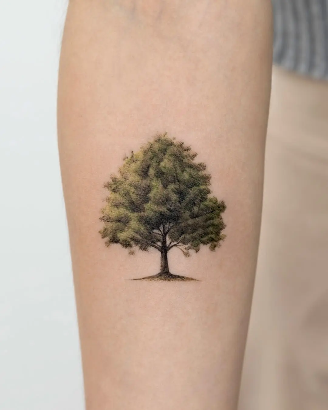 Elegant tree tattoo with vibrant green hues