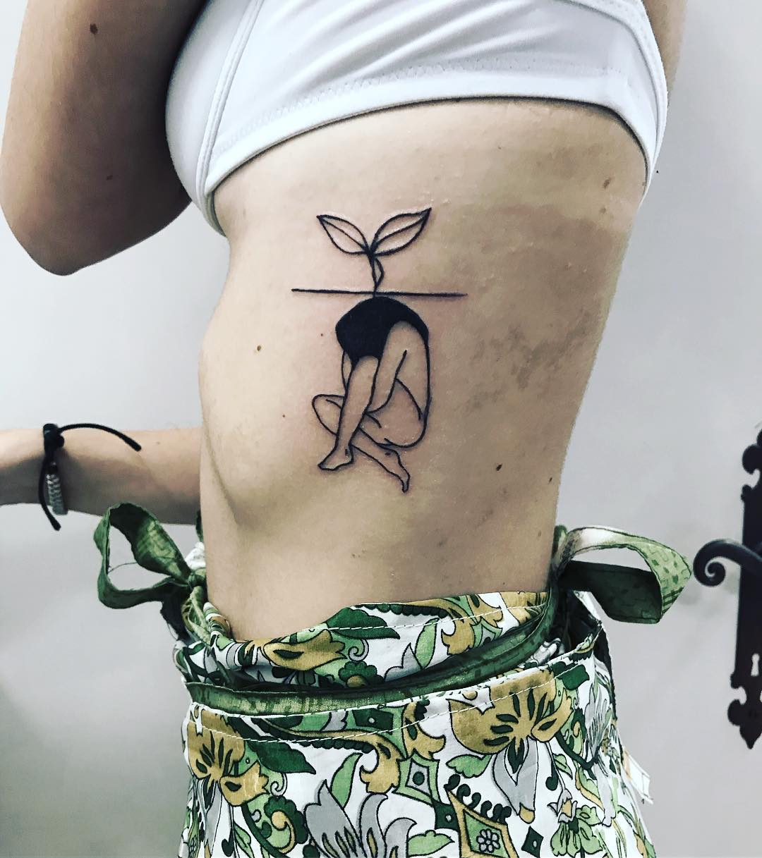 Minimalist tattoo symbolizing growth and rebirth