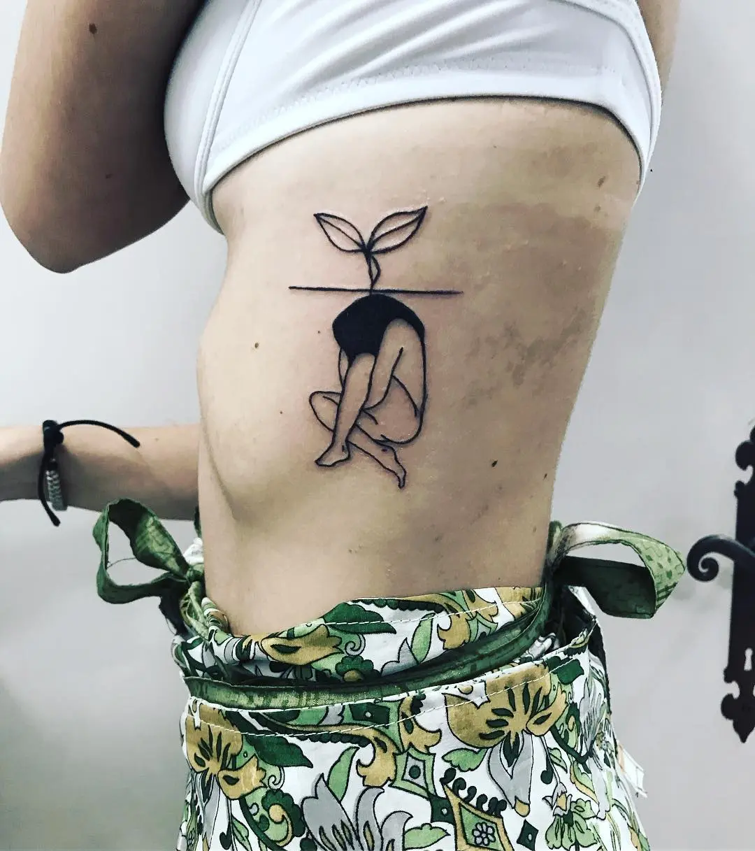 Minimalist tattoo symbolizing growth and rebirth