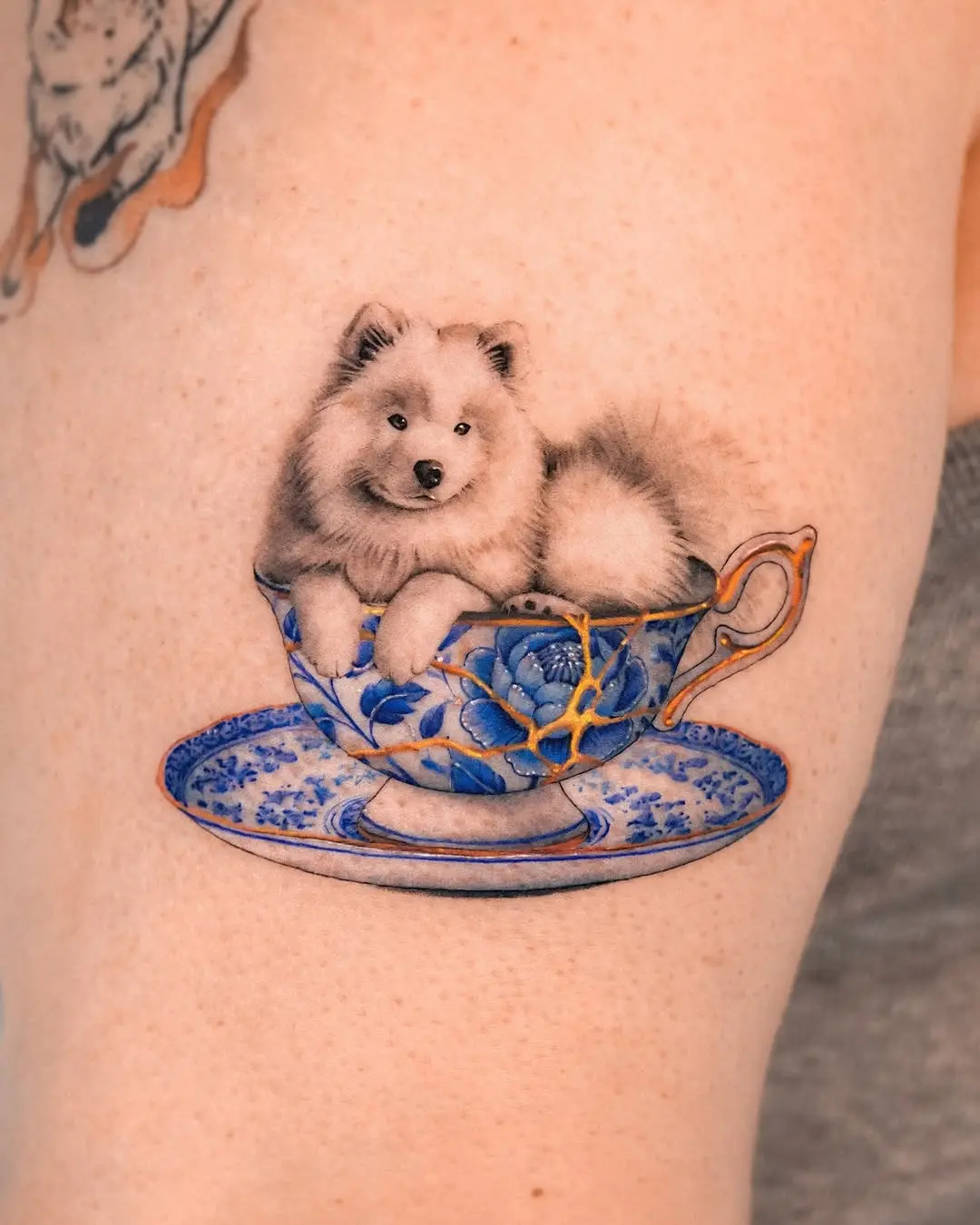 Charming samoyed in a delicate teacup tattoo