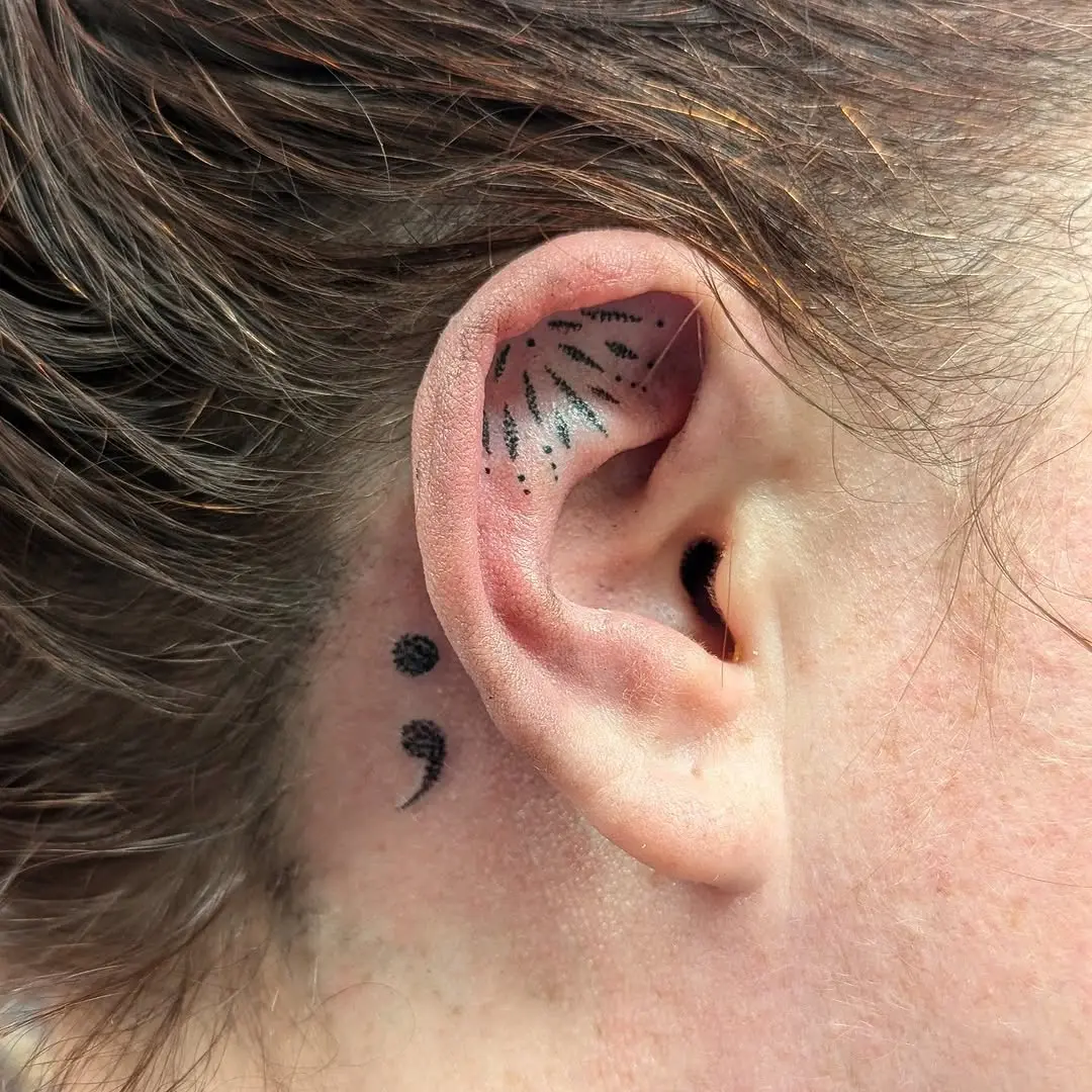 Unique semicolon tattoo behind the ear