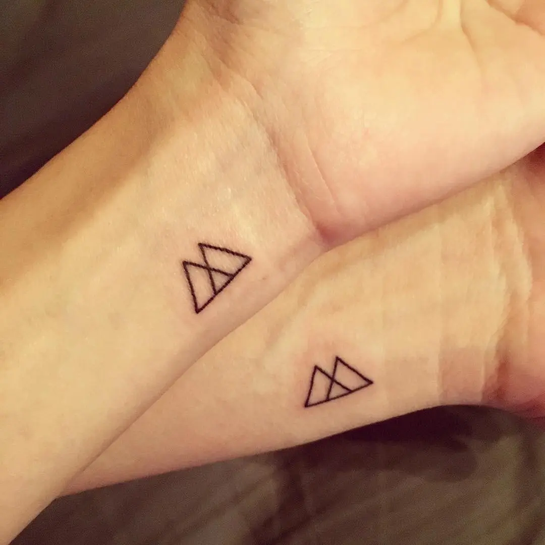 Minimalist sibling tattoos with geometric designs