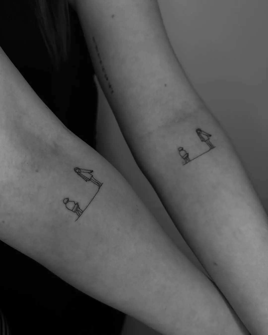 Minimalistic sibling tattoos in black and white