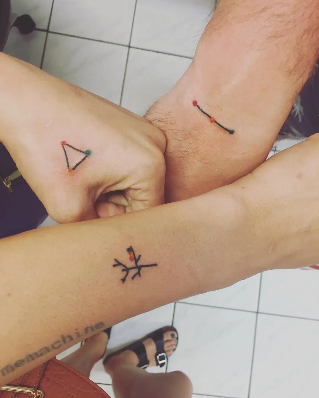 Meaningful geometric sibling tattoos showcasing bond