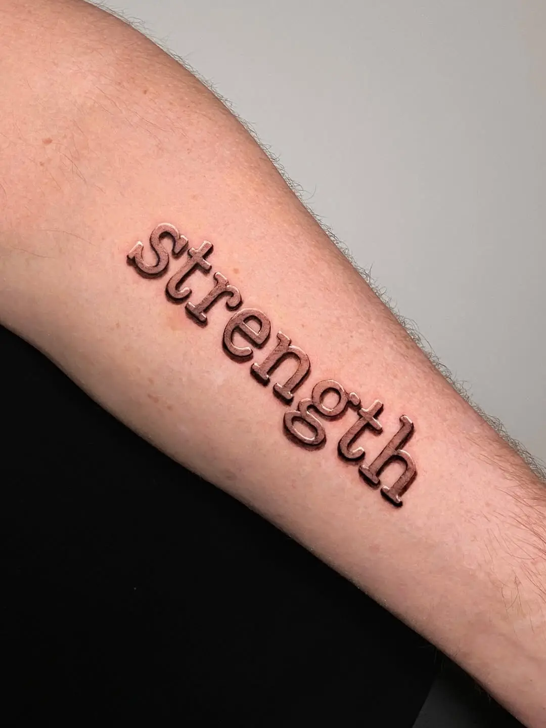 Powerful strength tattoo on the forearm