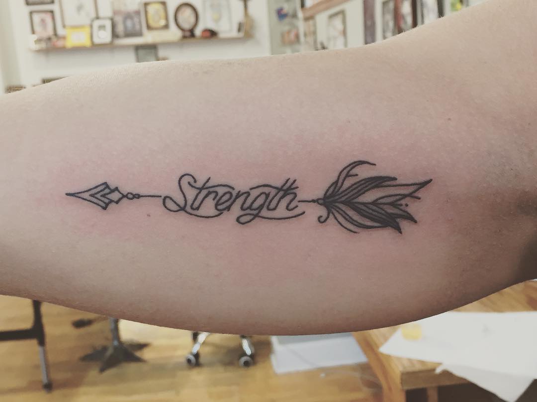 Elegant Strength Tattoo with Arrow Motif