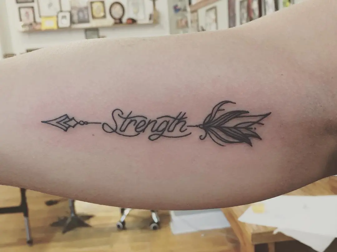 Elegant Strength Tattoo with Arrow Motif