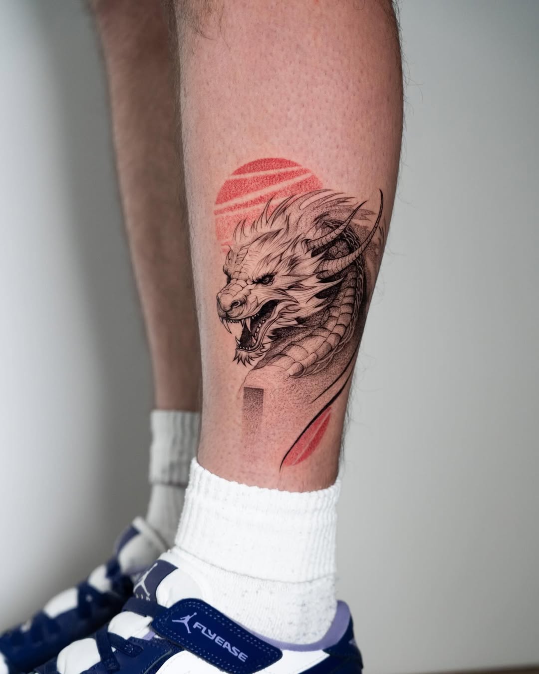 Powerful dragon tattoo on calf exudes strength